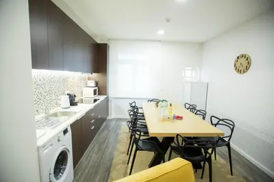 a kitchen with a table and chairs in a kitchen at Boavista Premium Family & Business by Porto City Hosts in Porto