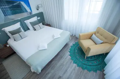 a bedroom with a bed and a chair at Boavista Premium Family & Business by Porto City Hosts in Porto