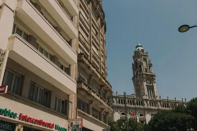a clock tower in the distance with a building at Puro Apartment in Porto