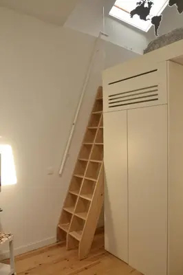 a staircase in a room with a white closet at InvictaViews Loft in Vila Nova de Gaia