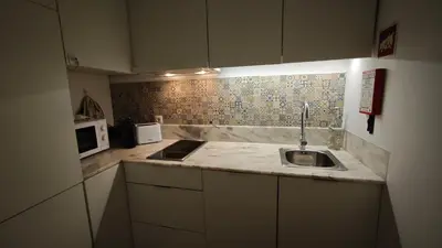 a small kitchen with a sink and a microwave at InvictaViews Loft in Vila Nova de Gaia