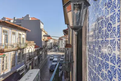 a street view of a city with a light pole at Azulejos Duplex Apartment - Porto Downtown in Porto