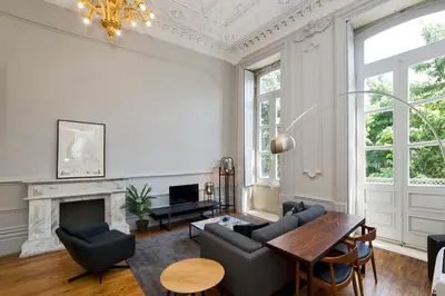 a living room with a fireplace and a table at Oporto Royal Apartment - Solar da Avenida in Porto