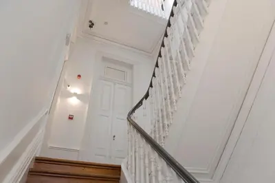 a staircase with white walls and a white door at Oporto Royal Apartment - Solar da Avenida in Porto