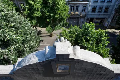a statue of a person on top of a building at Oporto Avenue Attic - Solar da Avenida in Porto