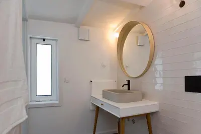 a bathroom with a sink and a mirror at Oporto Avenue Attic - Solar da Avenida in Porto