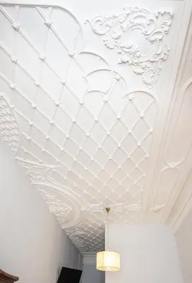 a room with a white ceiling with a chandelier at Almada Guest House in Porto