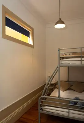 a bedroom with a bunk bed and a window at Oporto Sky Hostel in Porto