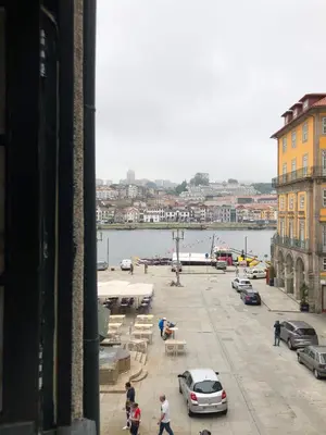 a view of a parking lot with cars and a harbor at PortoSense Ribeira in Porto