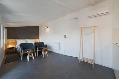 a room with two chairs and a bed and a table at Oporto Design Attic - Solar da Avenida in Porto