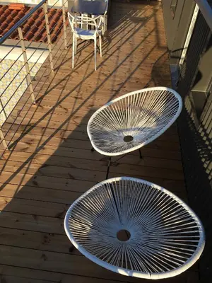 two metal tables and a chair on a deck at Oporto Design Attic - Solar da Avenida in Porto