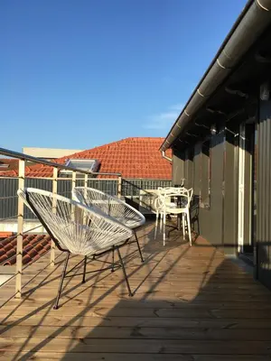 a deck with tables and chairs on a building at Oporto Design Attic - Solar da Avenida in Porto