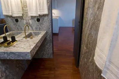 a bathroom with a marble sink and a mirror at Oporto Cozy Design Studio - Solar da Avenida in Porto
