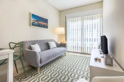 a living room with a couch and a table at Santa Catarina Modern Flat in Porto