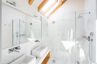 a white bathroom with a sink and a shower at Thomaz Palace in Porto
