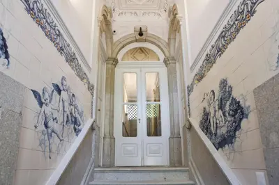 a white door in a hallway with paintings on the walls at Oporto Cozy Design Studio II - Solar da Avenida in Porto