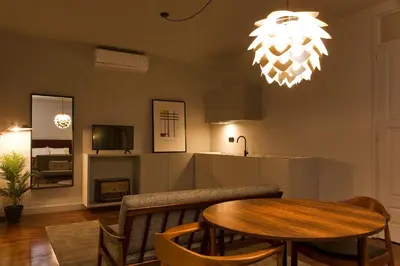 a dining room with a table and a chandelier at Oporto Cozy Design Studio II - Solar da Avenida in Porto