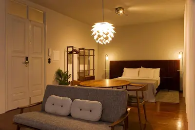 a living room with a bed and a couch and a table at Oporto Cozy Design Studio II - Solar da Avenida in Porto