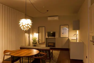 a living room with a table and a dining room at Oporto Cozy Design Studio II - Solar da Avenida in Porto