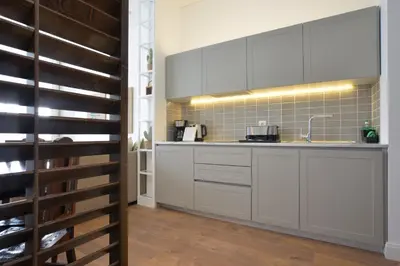 a kitchen with white cabinets and a wine cellar at Spot Apartments Casa Januario in Porto