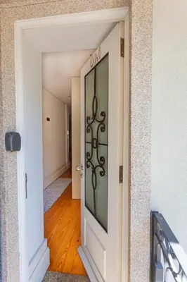 a door into a hallway with a hallway leading into a room at Citybreak-Apartments Poveiros in Porto