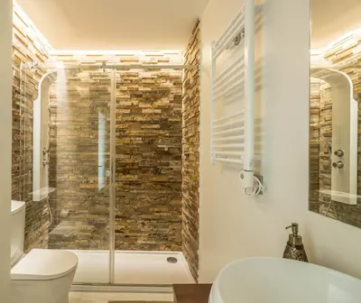 a bathroom with a glass shower with a toilet at House General Torres in Vila Nova de Gaia