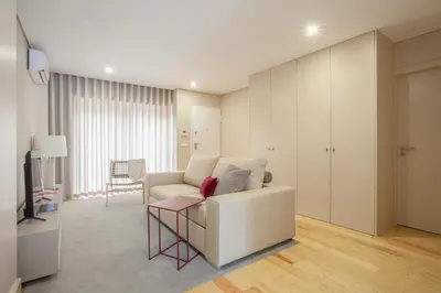 a living room with a white couch and a television at Liiiving in Porto | Luxury Boutique Apartment in Porto