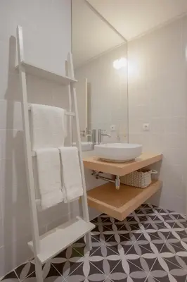 a bathroom with a sink and a mirror at Liiiving in Porto | Luxury Boutique Apartment in Porto