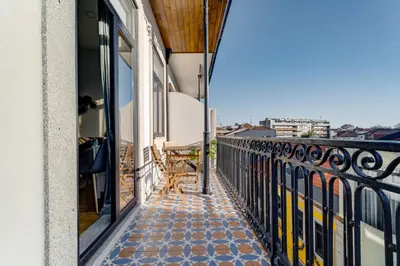 a balcony with a bench on a building at Nomad's Netto & Subway in Porto
