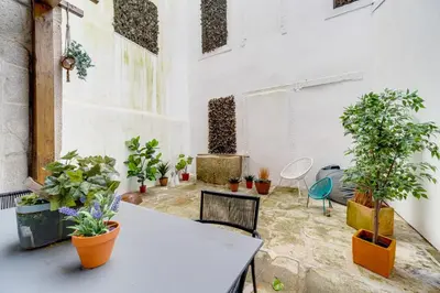 a room with a table and potted plants at Nomad's Netto & Subway in Porto