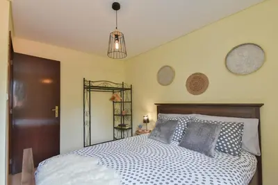a bedroom with a bed with a wooden headboard at Clerigos Old Town Apartment in Porto