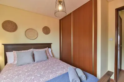 a bedroom with a bed and a wooden wall at Clerigos Old Town Apartment in Porto