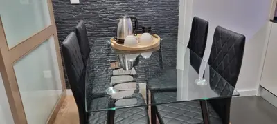 a dining room with black chairs and a glass table at Alexandre Herculano Oporto Residence I II & III in Porto