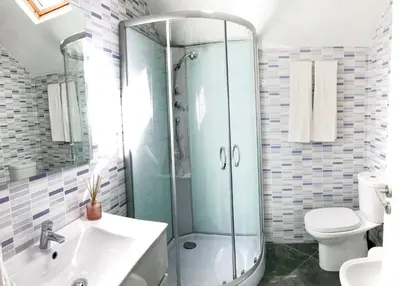 a bathroom with a shower and a sink and a toilet at Porto Luxury Apartments in Vila Nova de Gaia