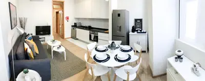a kitchen and a dining room with a table and chairs at Porto Luxury Apartments in Vila Nova de Gaia