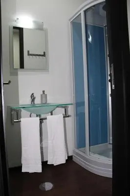 a bathroom with a sink and a shower with towels at 12 Short Term in Porto
