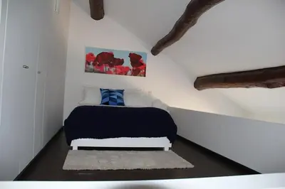 a bedroom with a bed in the corner of a room at 12 Short Term in Porto