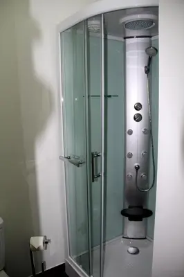 a shower in a bathroom with a glass shower stall at 12 Short Term in Porto