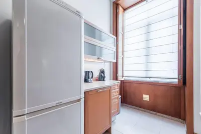a kitchen with a refrigerator and a window at GuestReady - Amaryllis Apartment in Porto