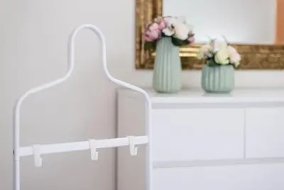 a white table with two vases of flowers on it at GuestReady - Amaryllis Apartment in Porto