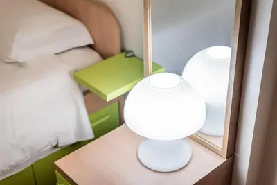 two white lamps on a table in a bedroom at GuestReady - Amaryllis Apartment in Porto