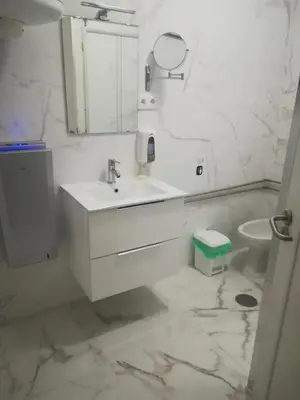a white bathroom with a sink and a toilet at Hotel Cristo Rei in Porto
