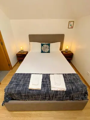 a bedroom with a bed with two towels on it at Vitral House of Art District in Porto