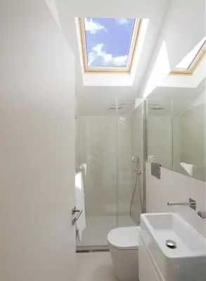 a bathroom with a toilet and a sink and a skylight at HM - Flores Skylight in Porto