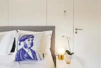 a bed with a painting of a man on it at HM - Flores Skylight in Porto