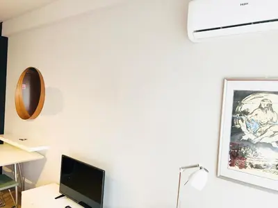 a room with a desk with a computer and a picture on the wall at Bolhão Studio in Porto