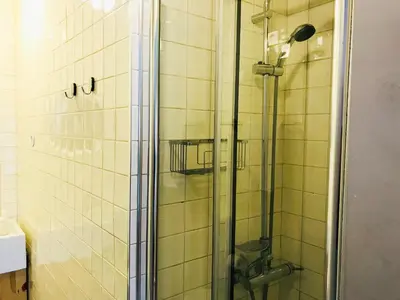 a shower with a glass door in a bathroom at Bolhão Studio in Porto