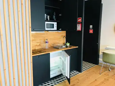 a small kitchen with a counter and a sink at Bolhão Studio in Porto