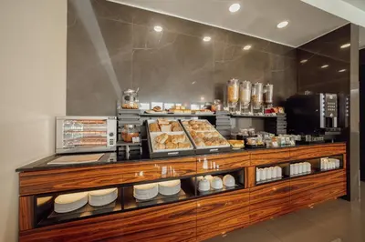 a bakery counter with pastries and other food items at ABC Hotel Porto - Boavista in Porto