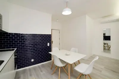 a dining room with a white table and white chairs at My Modern Homey at Porto in Porto